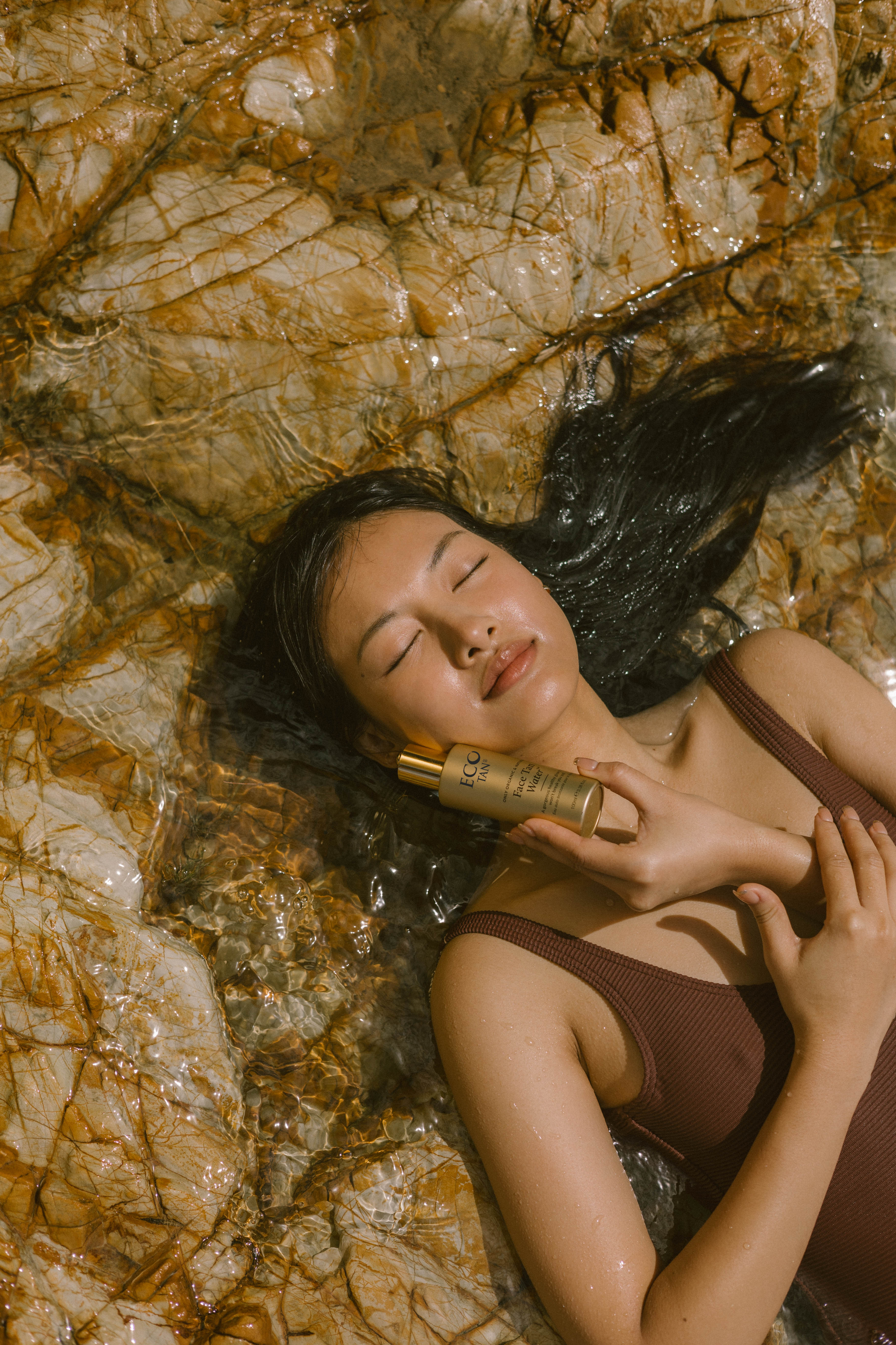 Eco Tan-Face Tan Water-Sun Care-FaceTanWater_ET_Charlize_KantamonBeachRocks_Portrait-The Detox Market | 